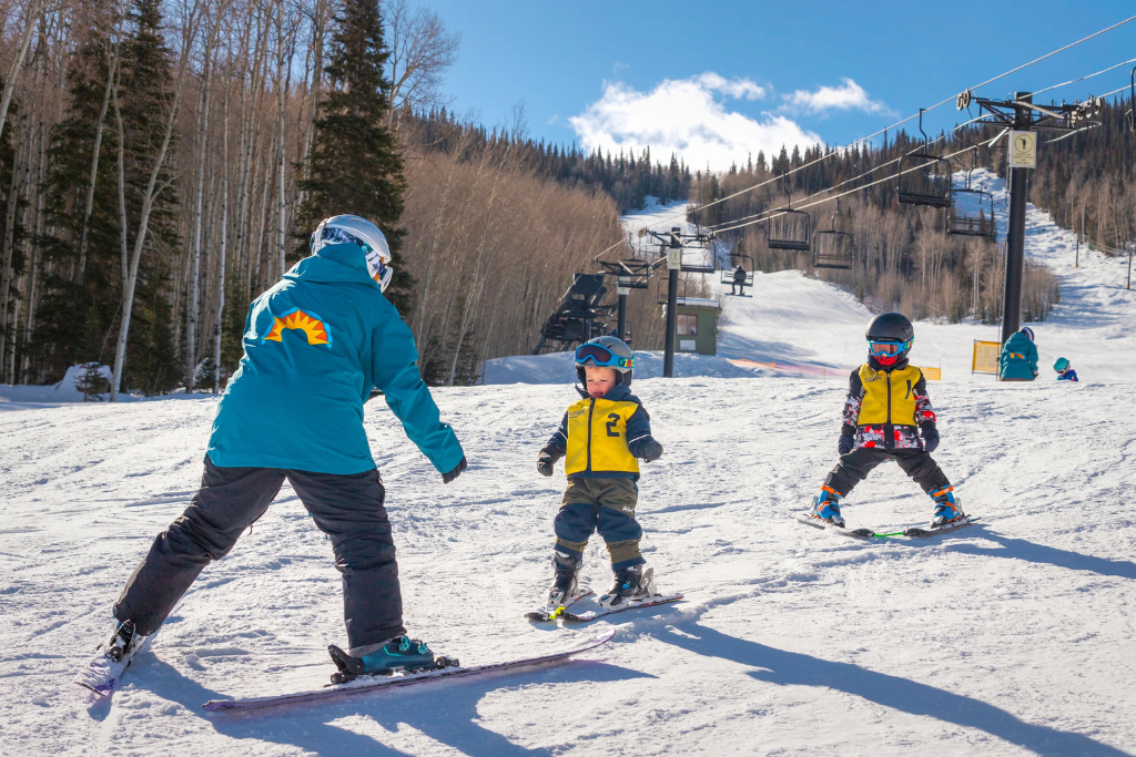 Two young kids taking lessons at Sunlight Ski & Ride School