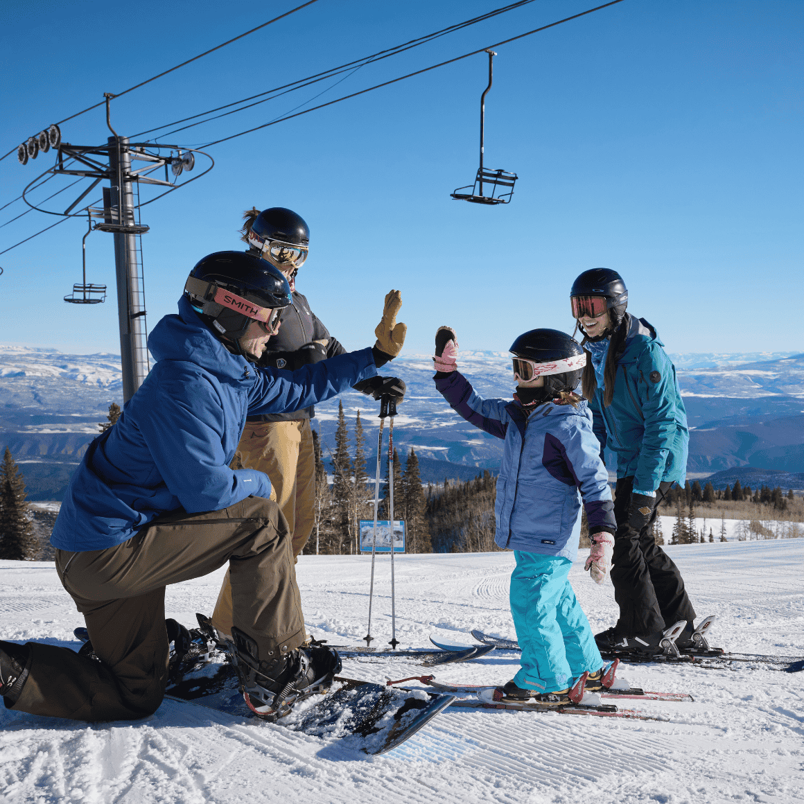 family high fives at sunlight mountain in glenwood springs