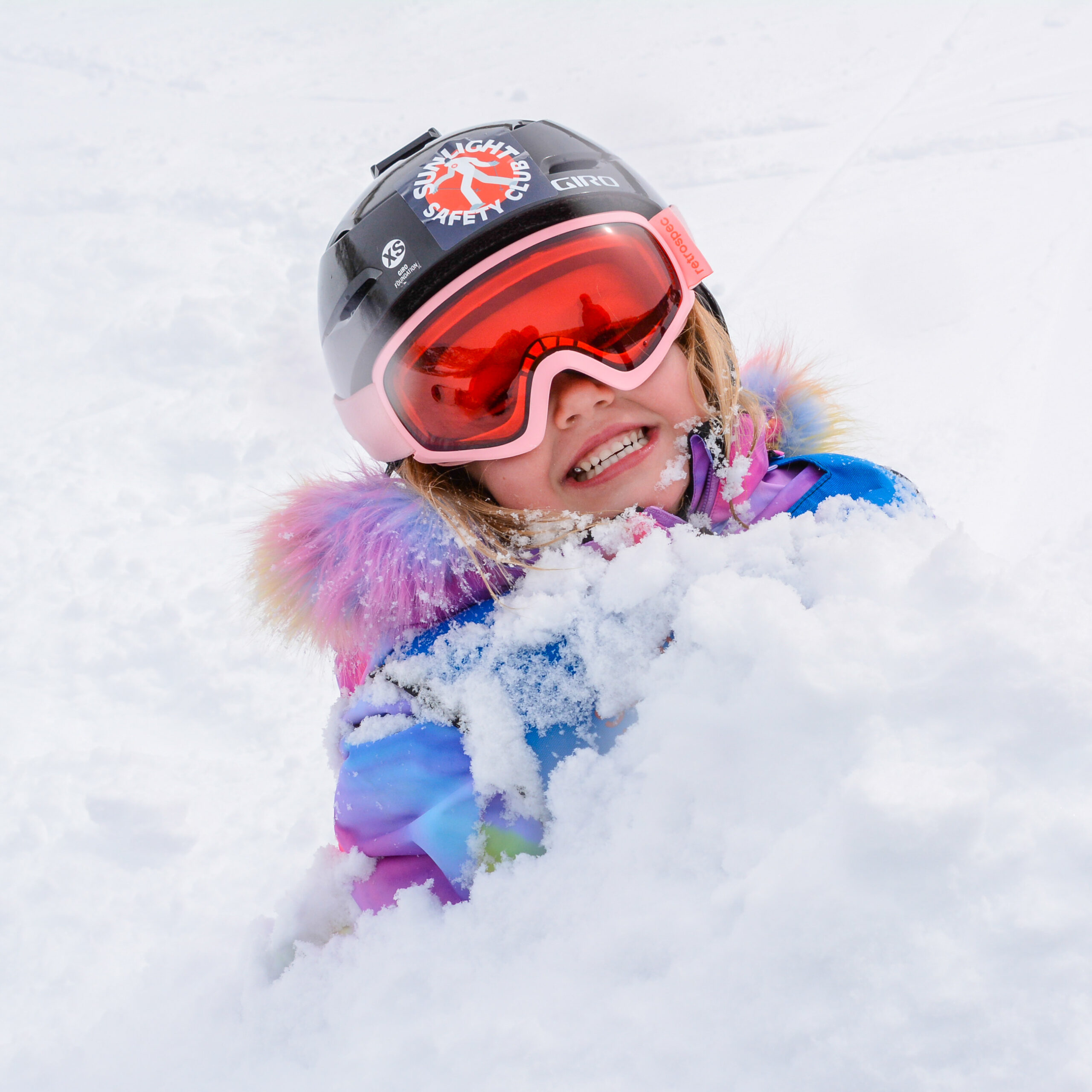 child in snow at sunlight mountain