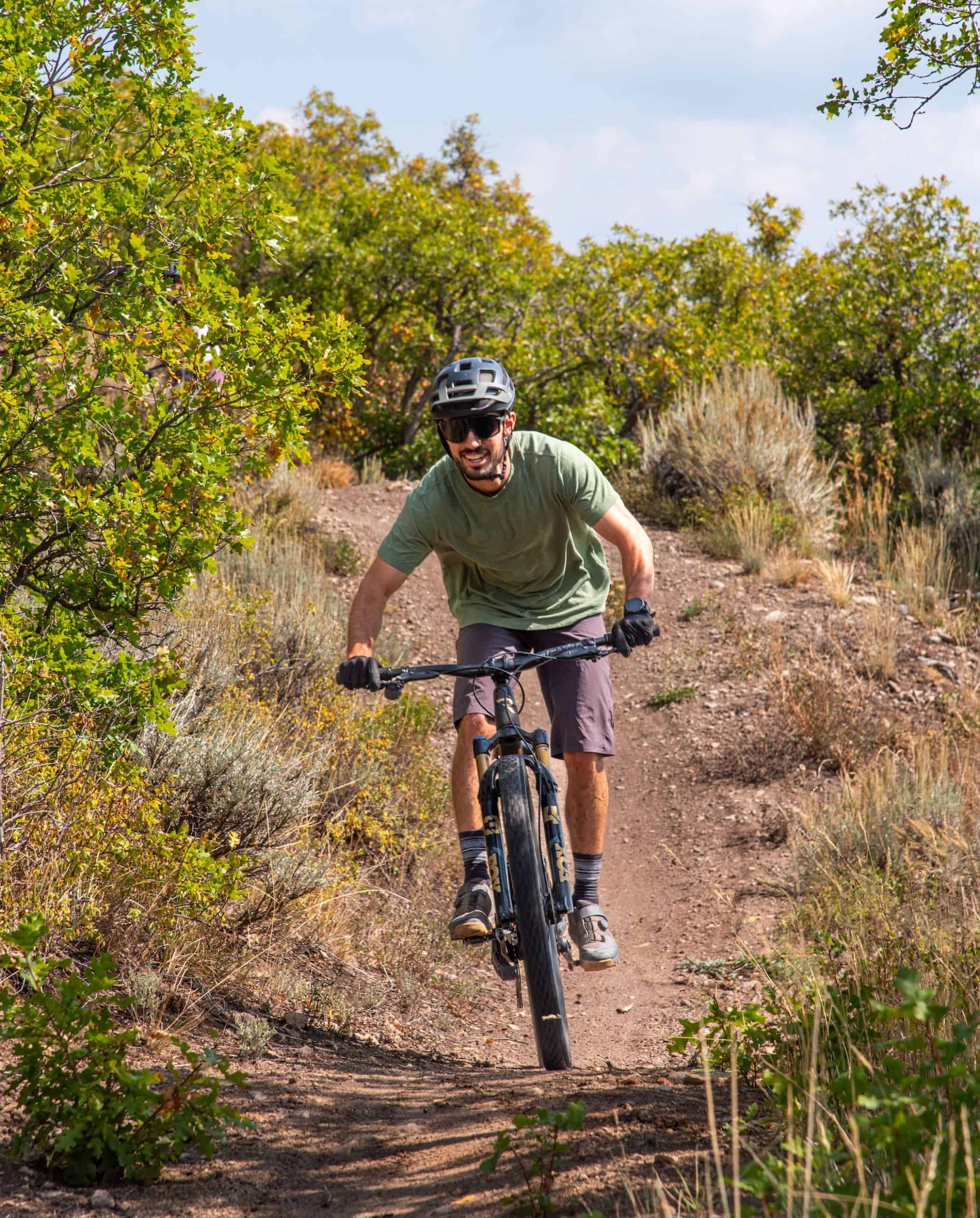 A man rides a mountain bike on a dirt trail